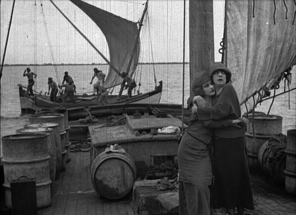 Rose Arnold (Jane Gail) and her sister Polly (Ruth Pecheur) attacked by pirates, in Bitter Fruit (1920)